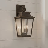 Bronze Beckett outdoor wall light fixture on a white wooden horizontal siding.