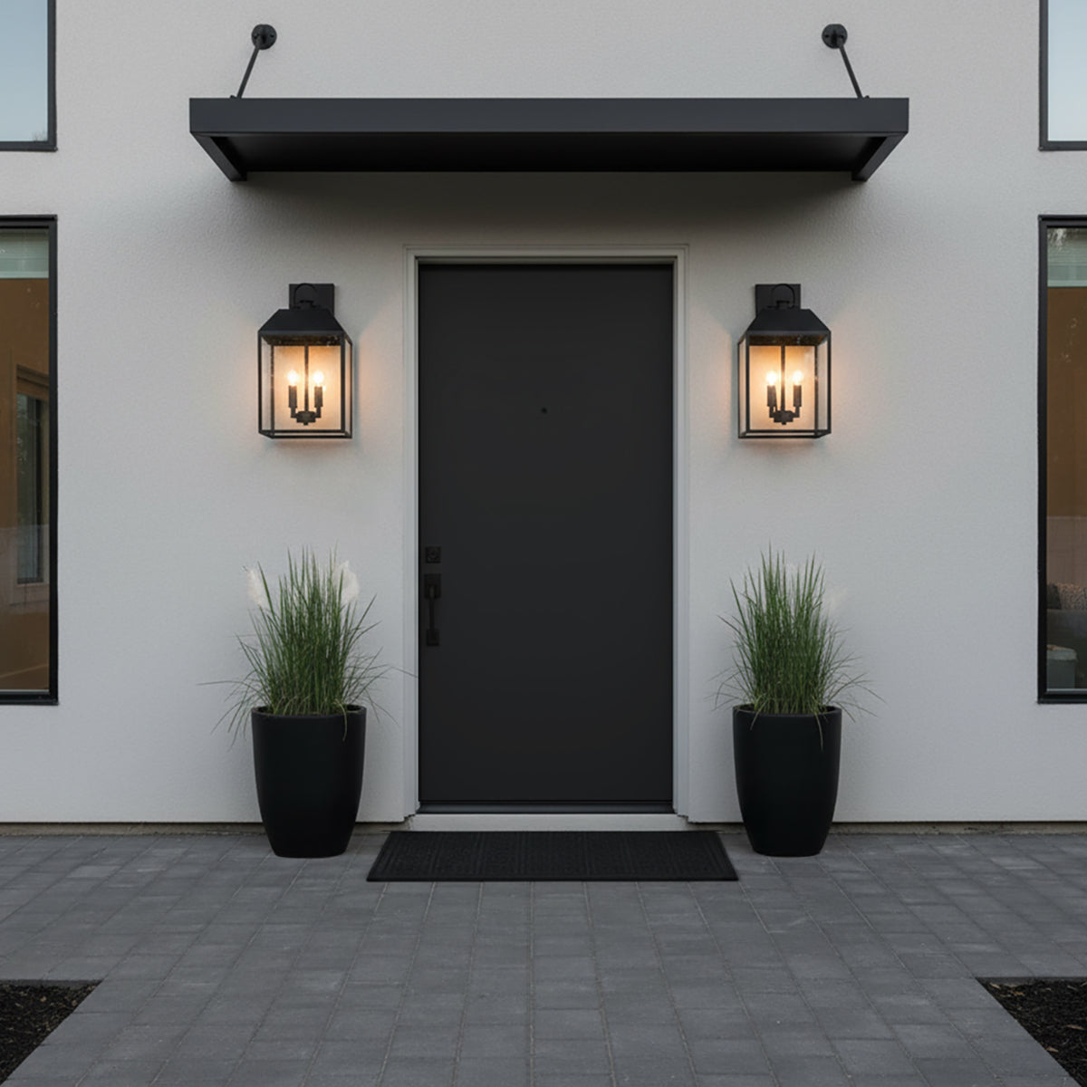 Porter Outdoor Wall Light, Medium 19" Black - Front view of a black door with two sconces on either side.