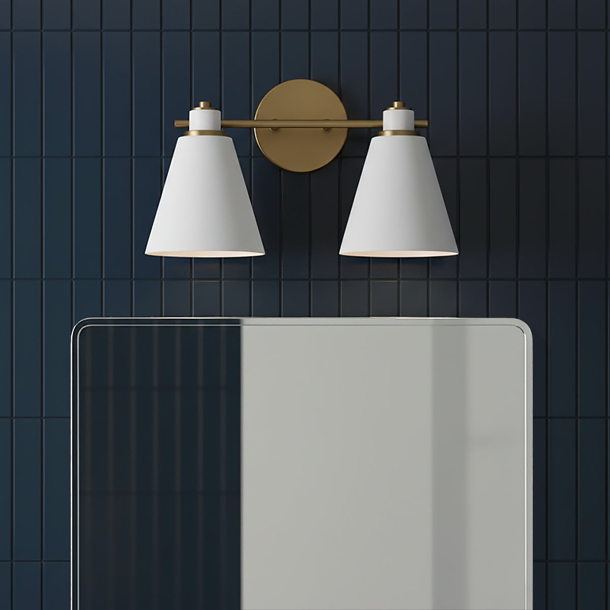 Avin 2 Light Vanity, White and Aged Brass - A modern vanity light with two white conical shades and aged brass accents mounted on a dark blue tiled wall above a reflective mirror.