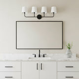 Elowen 4 Light Vanity Light, in Matte Black, shown above a single sink and wide horizontal mirror in a neutral decorated bathroom.