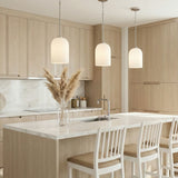 Elira Pendant 9", Brushed Nickel globe Pendant in a Modern Kitchen with a white marble island.