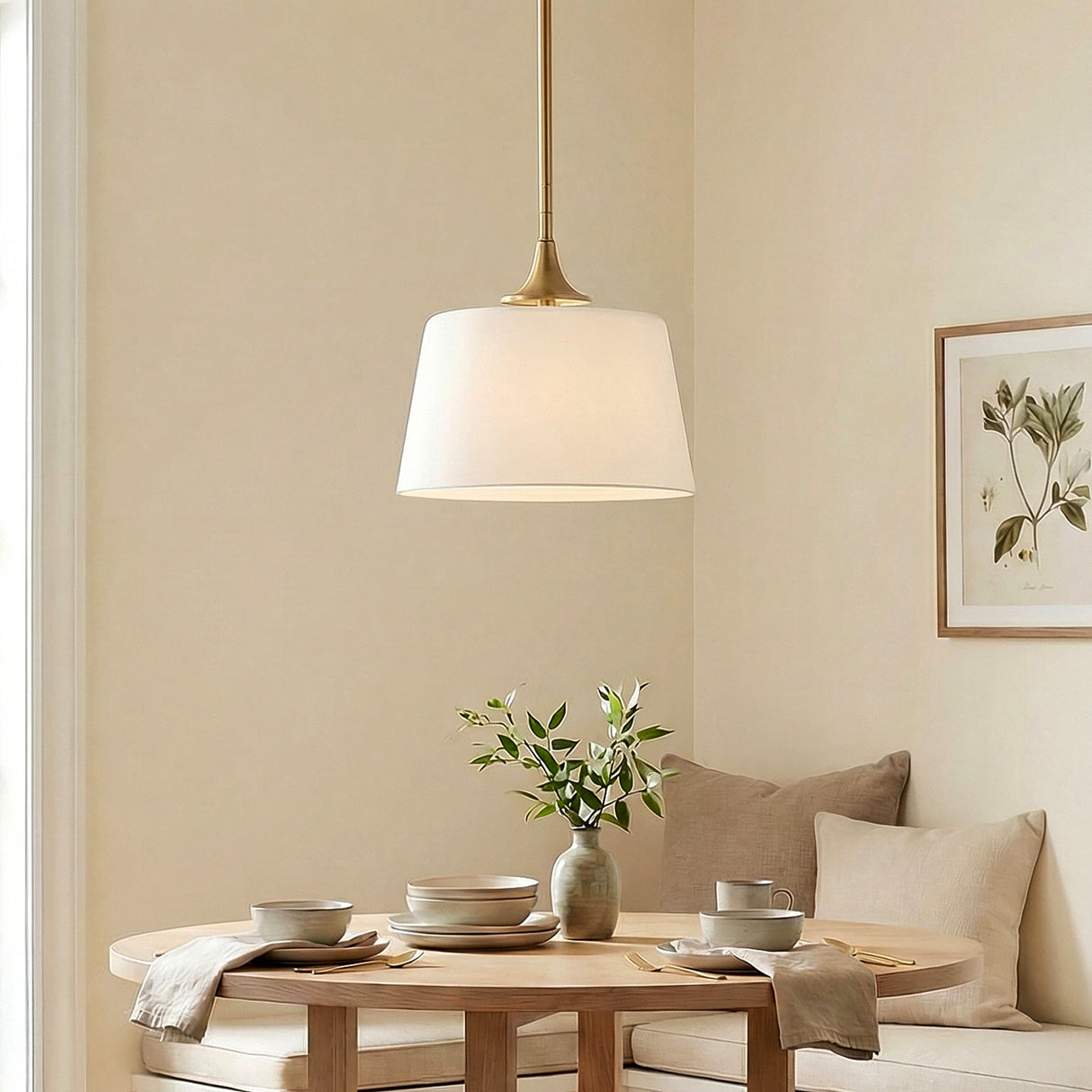 Harper Pendant 12", Aged Brass geometric fabric pendant in a Transitional Dining Room with a round oak table and built-in bench.