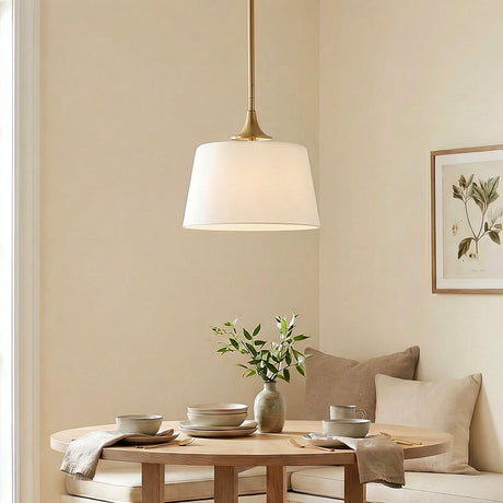 Harper Pendant 12", Aged Brass geometric fabric pendant in a Transitional Dining Room with a round oak table and built-in bench.