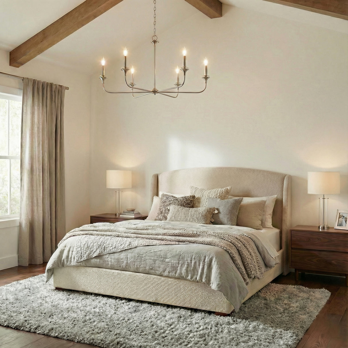 Sloan 32" Brushed Nickel scalloped chandelier in a Transitional Bedroom with a beige upholstered bed and wooden beams.