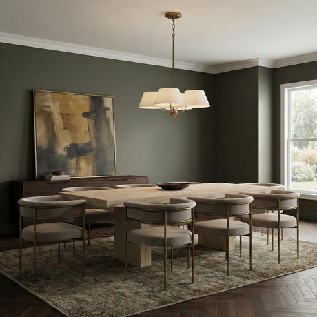 Colton 4 Light Chandelier 26", Aged Brass geometric Chandelier in a Contemporary Dining Room with a travertine table and velvet chairs.