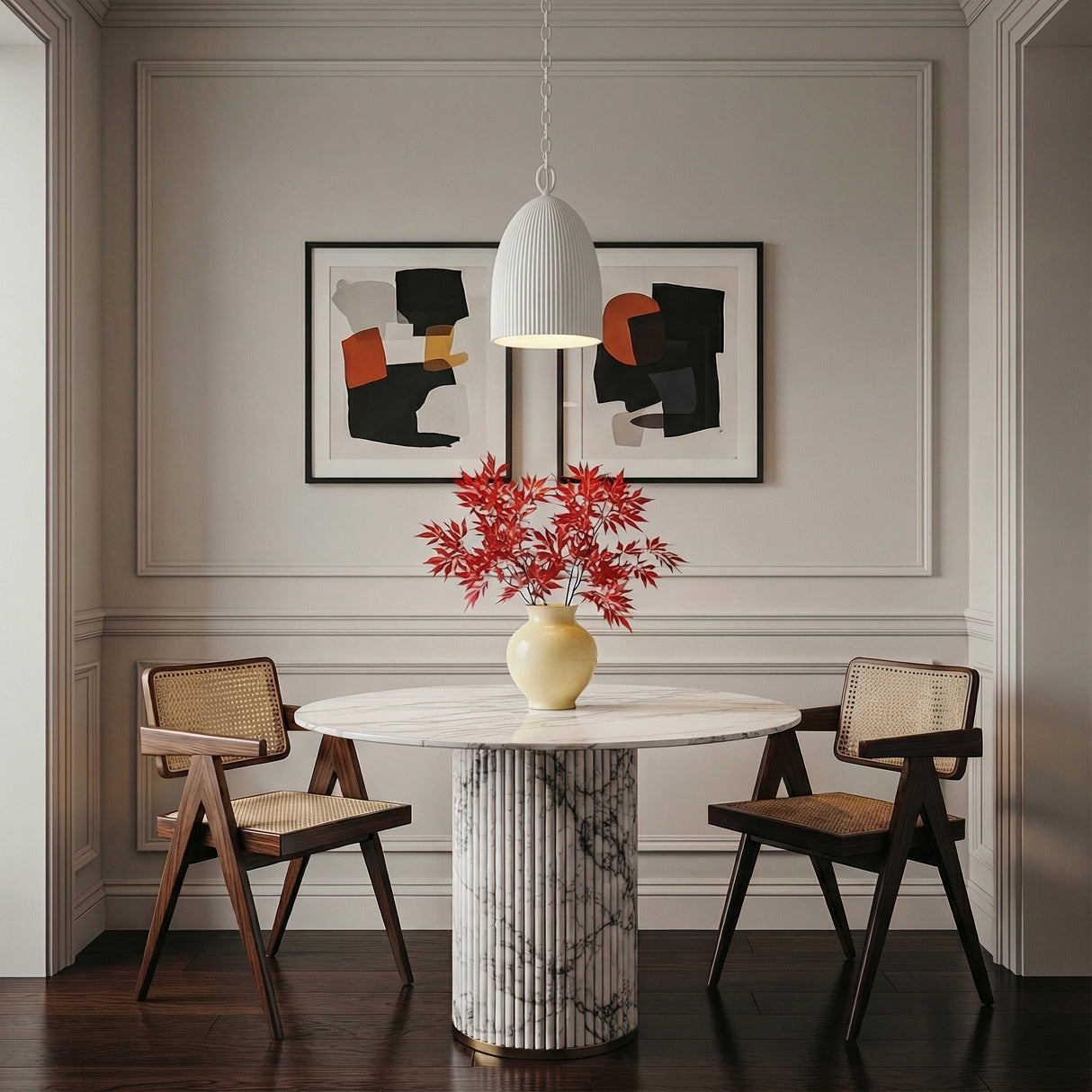 White geometric Pendant in a Transitional Dining Room with a white marble table and cane chairs.