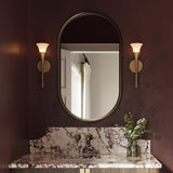 Deep burgundy powder room with marble countertops and two Fleur Wall Sconces  in Textured Brushed Brass finish on either side of the mirror