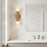 Modern bathroom interior with marble walls, a sink, and the Fleur 15" tall wall scone in textured brushed brass.