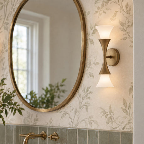 A transitional bathroom vanity features the Fleur 2 Light Wall Sconce in textured brushed brass mounted beside a round mirror above green subway tiles.