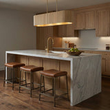 Leery Linear Pendant 44", Whitewash and Matte Brass linear pendant in a Transitional Kitchen with a white marble island.