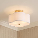 A transitional foyer with the Orla Semi-Flush 12", Brushed Gold featuring a scalloped white linen shade along the ceiling with beige wallpaper and white molding.