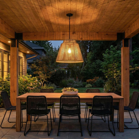 Luma Outdoor Pendant 23", Sienna and Black woven Outdoor Hanging in a Modern Farmhouse Outdoor with a wooden dining table and black chairs.