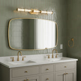 Elara LED 5 Light Vanity 38, Brass and Clear Glass - Bathroom with sage green tiled walls and a double sink vanity.