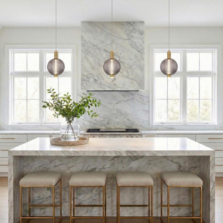 Nola LED Pendant 6", Brass and Ribbed Smoked Glass globe pendant in a Contemporary Kitchen with a white marble island.