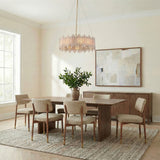 Colette 8 Light Chandelier 28", Antique Brass geometric chandelier in a Transitional Dining Room with a wood table and abstract art.