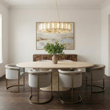 Avery Antique Brass geometric chandelier in a Transitional Dining Room with a travertine table and curved chairs.
