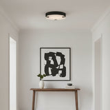Inez LED Flush Mount 16", Matte Black and Alabaster - A flush mount ceiling light in a white entryway.