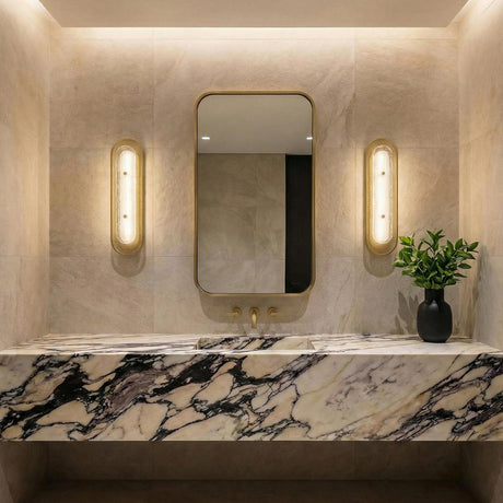 Vance LED Wall Sconce 22", Brass and Textured Glass geometric Wall Sconce in a Contemporary Bathroom with a veined marble vanity.