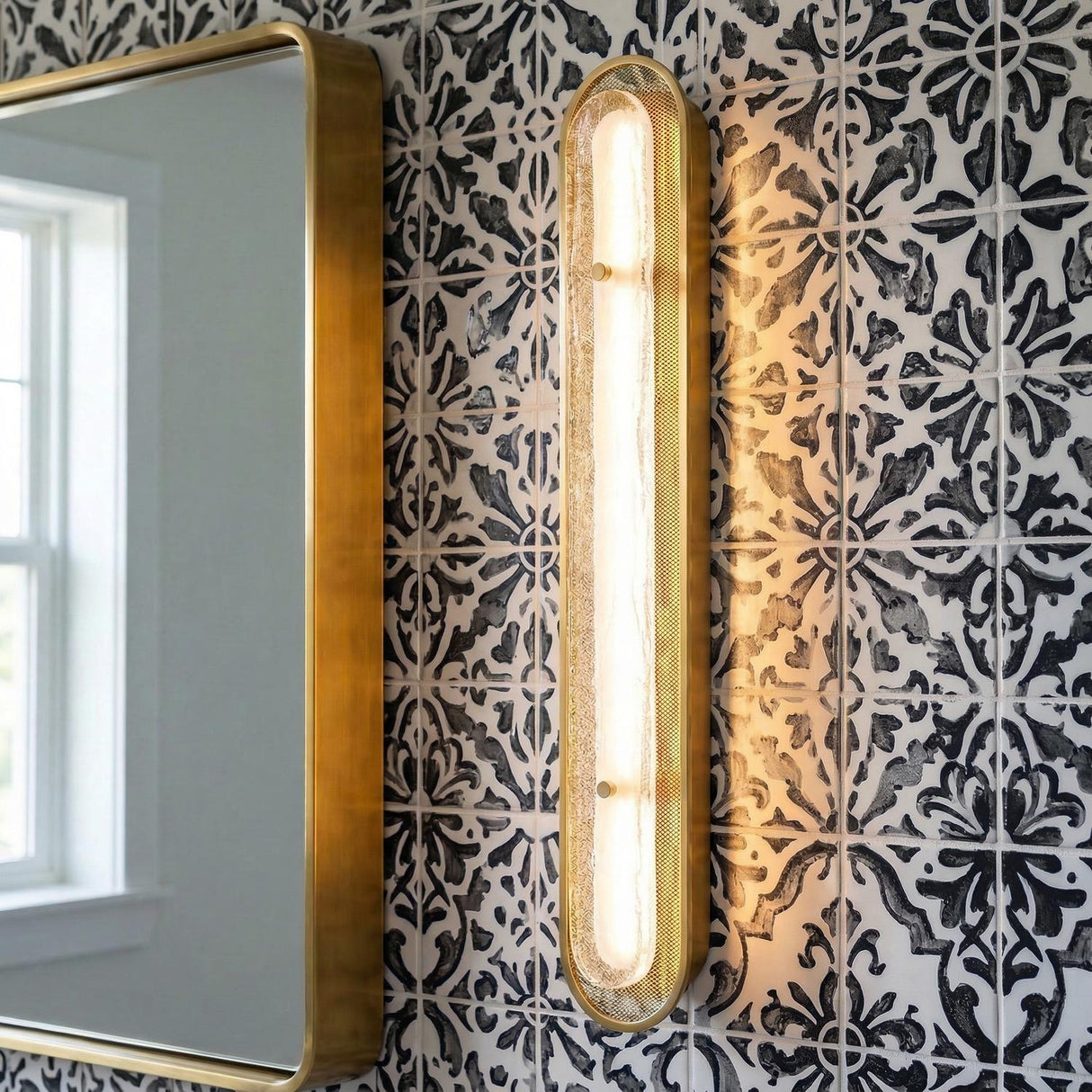 Vance LED Wall Sconce 38", Brass and Textured Glass linear geometric Wall Sconce in a Mediterranean Bathroom with a patterned tile wall.
