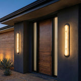 Vance LED Outdoor Wall Light 38", Black and Alabaster linear Outdoor Wall in a Modern Outdoor with a wooden front door.