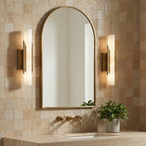 Delya LED Wall Sconce 16", Antique Brass and Alabaster styled in a Modern Bathroom with textured tile.