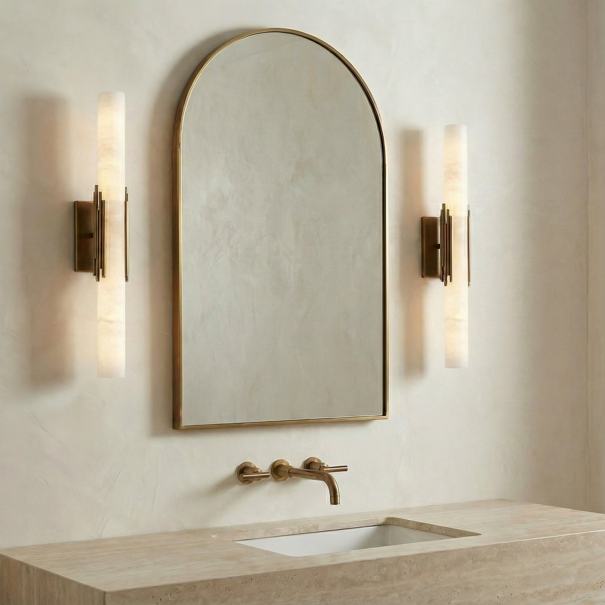 Delya LED Wall Sconce 22", Antique Brass and Alabaster linear Wall Sconce in a Modern Bathroom with an arched mirror and travertine vanity.
