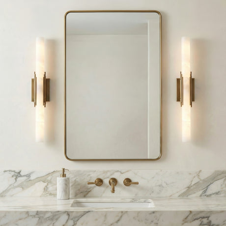 Delya LED Wall Sconce 28", Antique Brass and Alabaster linear Wall Sconce in a Contemporary Bathroom with a white marble vanity and gold mirror.