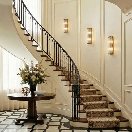 Nori Wall Sconce 14", Brass and Ribbed Glass Brass linear Wall Sconce in a Traditional Entryway with a curved staircase and floral decor.