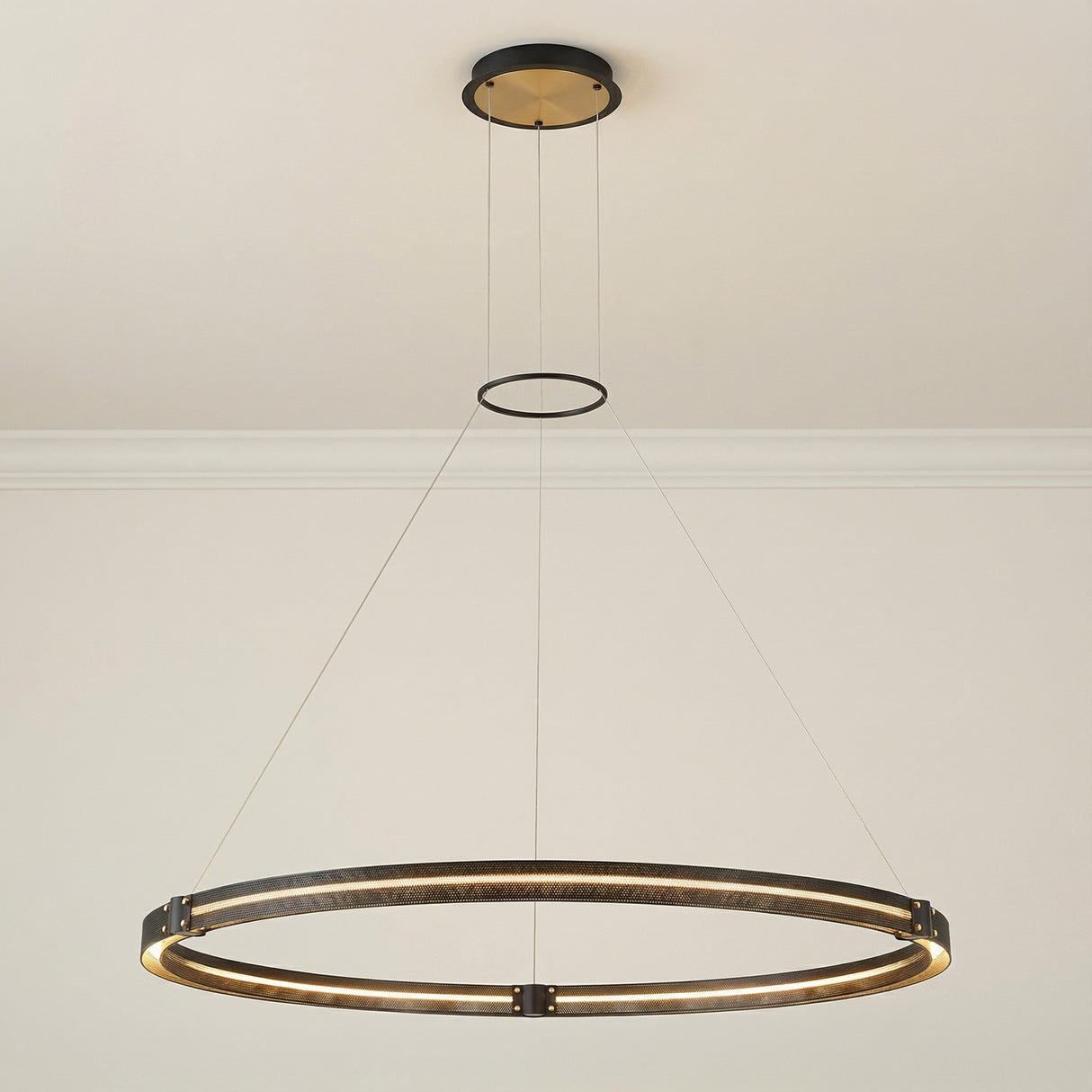 Brass and Black geometric Pendant in a Modern Living Room with clean walls and crown molding.
