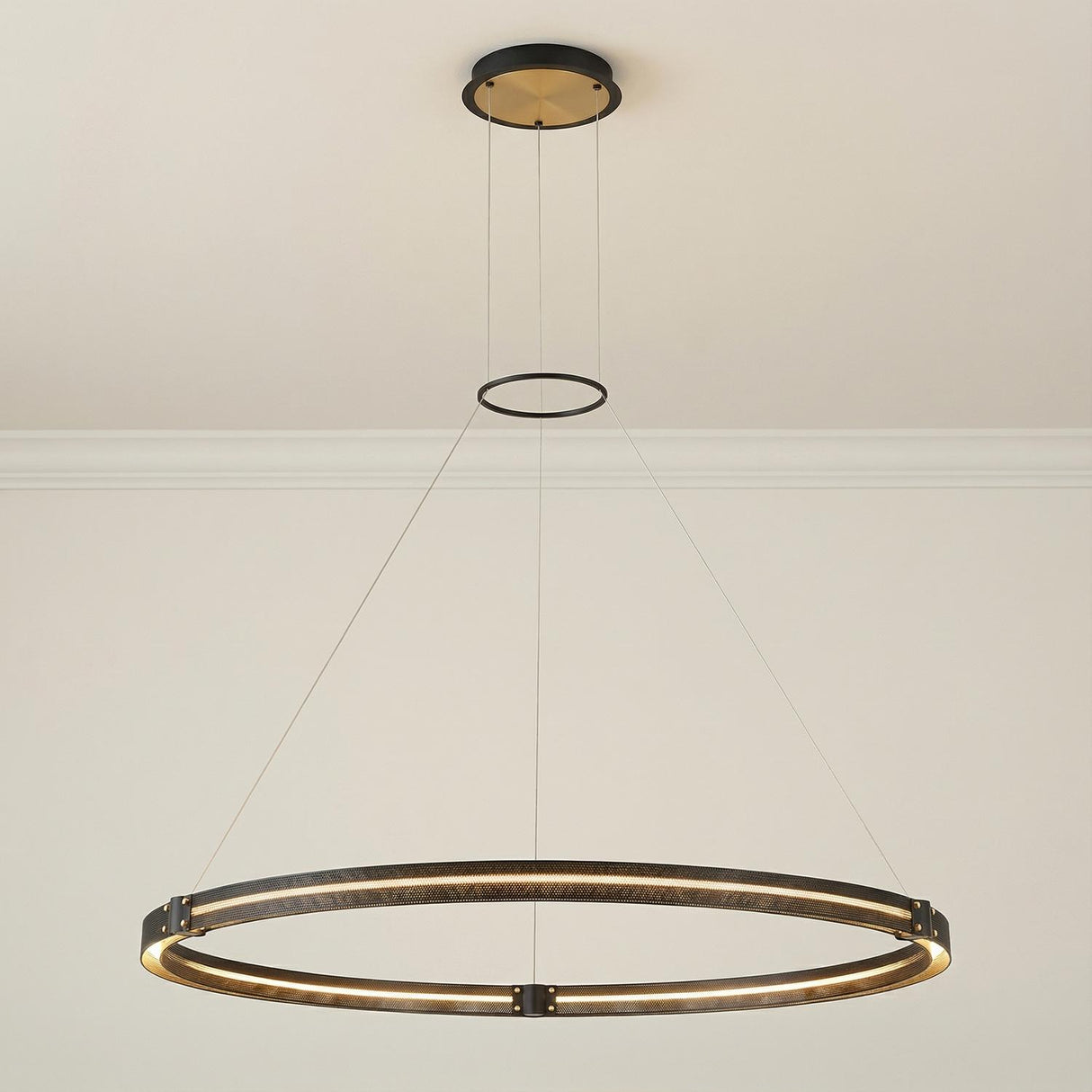Brass and Black geometric Pendant in a Modern Living Room with clean walls and crown molding.