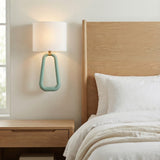 Boden Wall Sconce 20", Sage Green and Brass geometric wall sconce in a Modern Bedroom with a natural wood headboard.