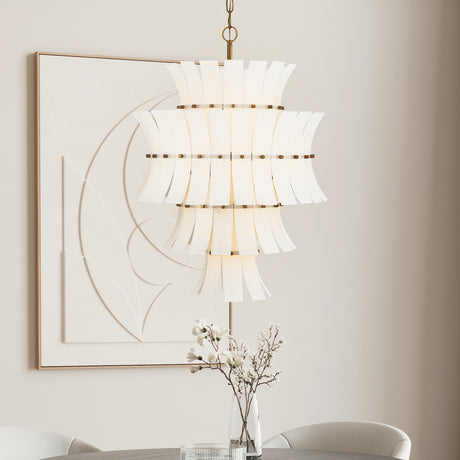 Brielle 13 Light Chandelier finished in  White Art Glass with Aged Brass is shown in a bright dining area in front of modern art. 