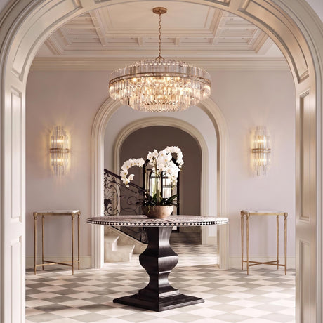 A traditional foyer features the Maxwell 32 Light Chandelier 41", Crystal with Aged Brass hanging from a coffered ceiling above a checkered tile floor.