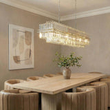 Maxwell 16 Light Linear Chandelier 50", Crystal with Polished Nickel linear Chandelier in a Contemporary Dining Room with tan chairs.