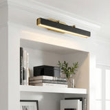 Jarrett LED Picture Light 32", Aged Brass & Tuxedo Leather linear wall sconce in a Transitional Living Room with a white built-in bookshelf.