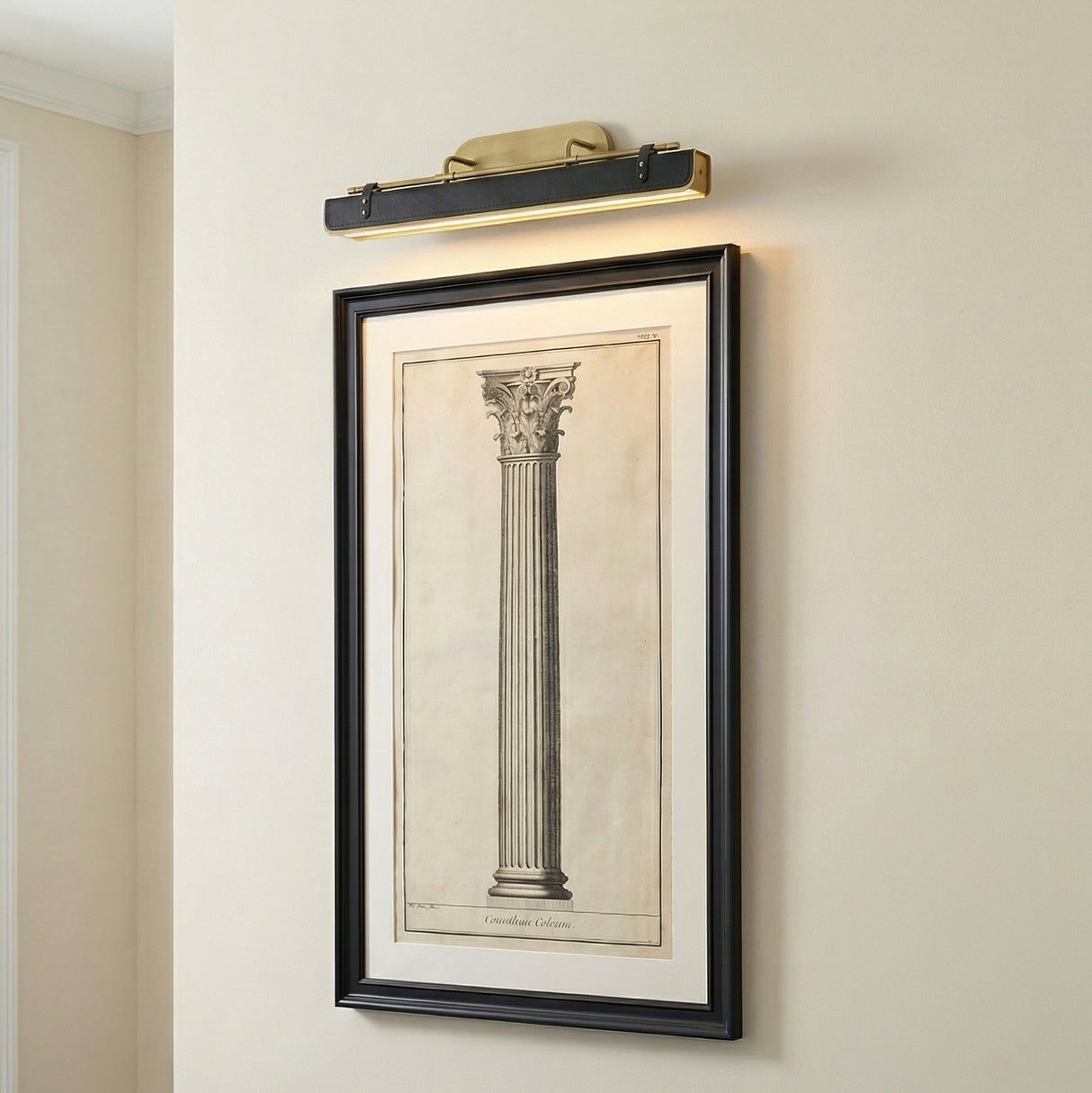 Jarrett LED Wall Light 32", Aged Brass and Tuxedo Leather linear wall sconce in a Transitional Entryway with classic framed art.