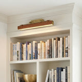 Jarrett LED Wall Light 32" in Aged Brass and Cognac Leather, styled in a Modern entryway with built-in shelving.