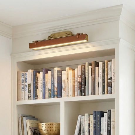 Jarrett LED Wall Light 32" in Aged Brass and Cognac Leather, styled in a Modern entryway with built-in shelving.