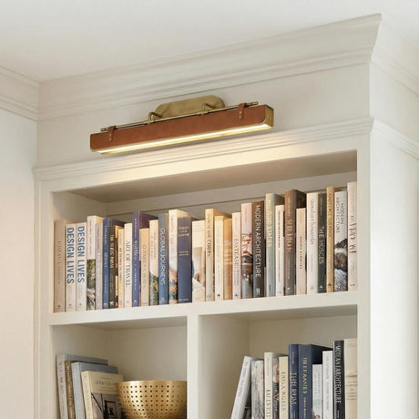 Jarrett LED Wall Light 32" in Aged Brass and Cognac Leather, styled in a Modern entryway with built-in shelving.