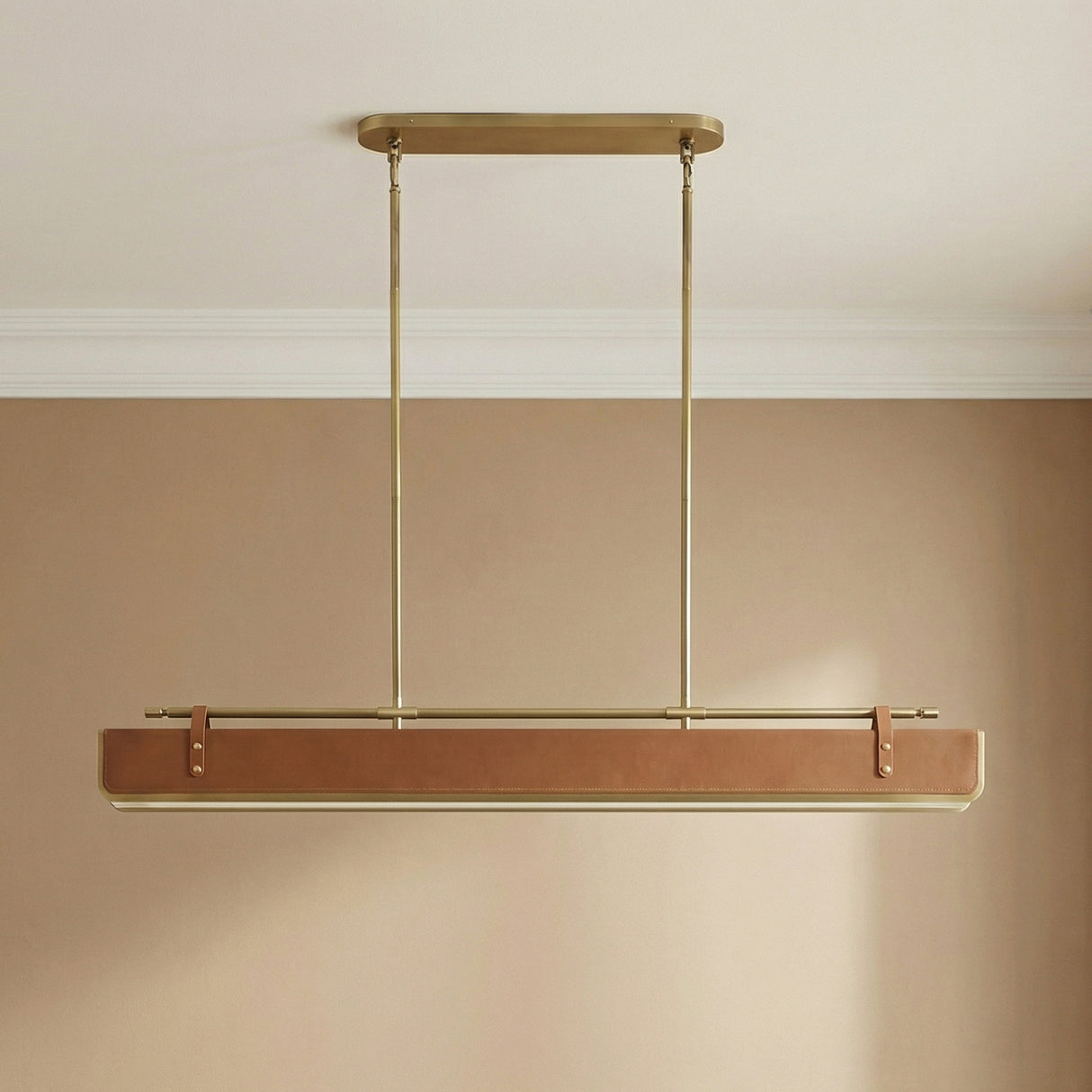 Jarrett LED Linear Pendant 60", Aged Brass and Cognac Leather linear pendant in a Transitional Dining Room.