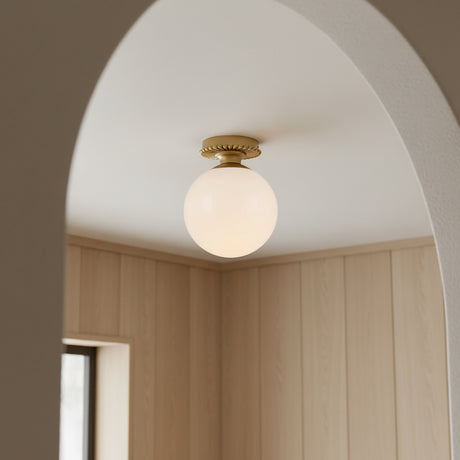 Amos Semi-Flush 8", Brushed Brass with Milk Glass ceiling light in a room with wooden paneling and an archway.