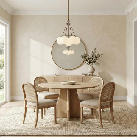 Soren Brass clustered globe design Chandelier in a Transitional Dining Room with a light oak table and cane back chairs.