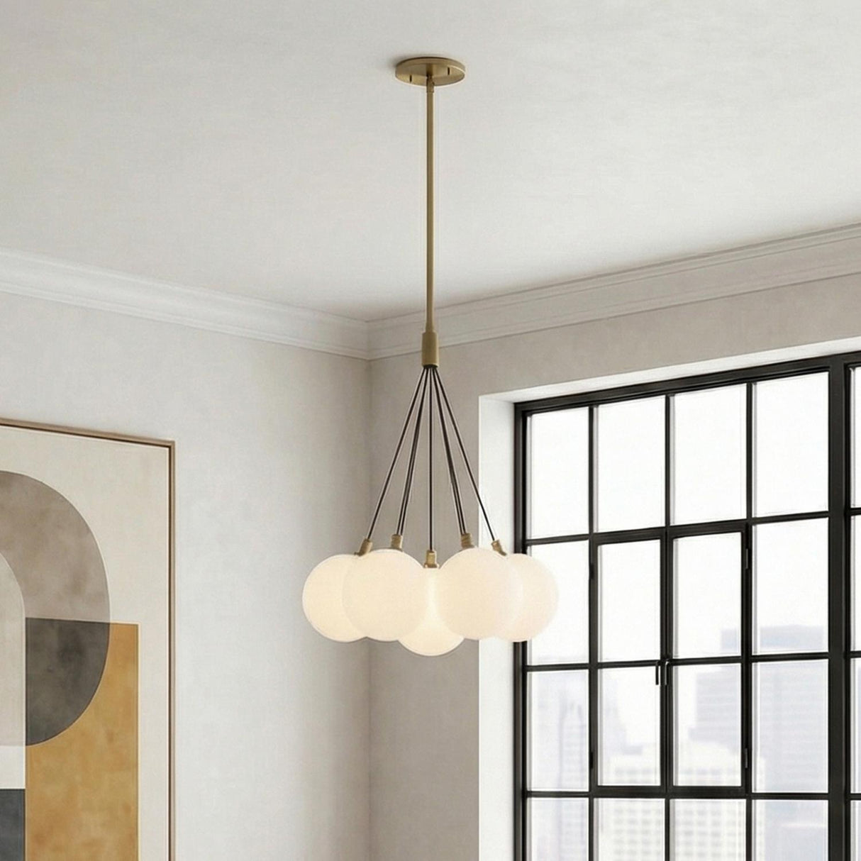 Soren 7 Light Brushed Brass globe Chandelier in a Modern Living Room with a black grid window and geometric art.