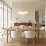 Soren 6 Light Chrome and Opal Glass globe Chandelier in a Contemporary Dining Room with a light oak table.