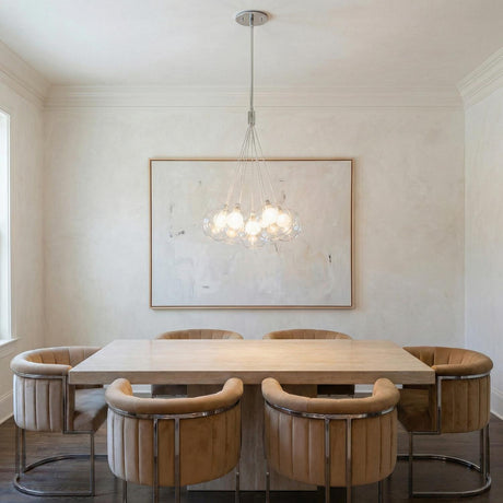 Soren 7 Light LED Chandelier 16", Chrome and Clear Glass globe Chandelier in a Contemporary Dining Room with a travertine table.
