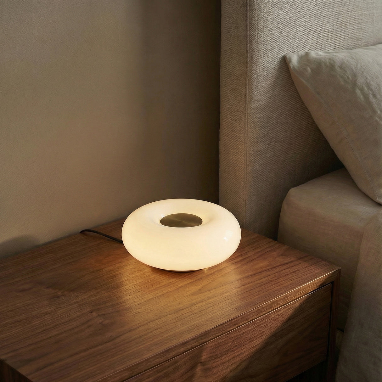 Otto LED Table Lamp 9", Aged Brass and Opal Glass geometric Table Lamp in a Modern Bedroom with a dark wood nightstand.