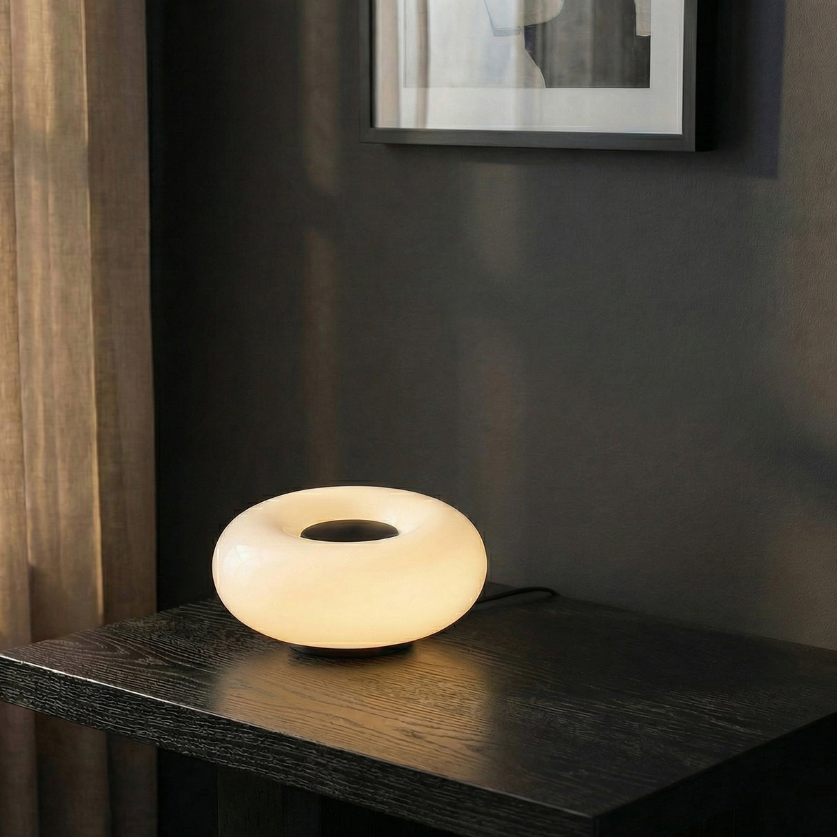 Otto LED Table Lamp 9, Matte Black and Opal Glass in a Modern Living Room on a dark wood table.