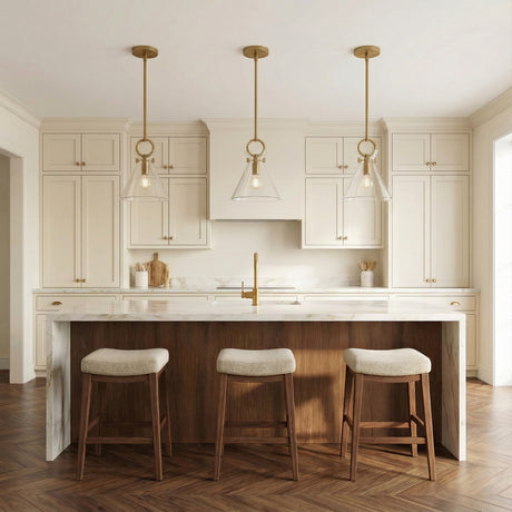 Aris Small Pendant 11, Aged Brass and Clear Glass, in a Transitional Kitchen with marble countertops.