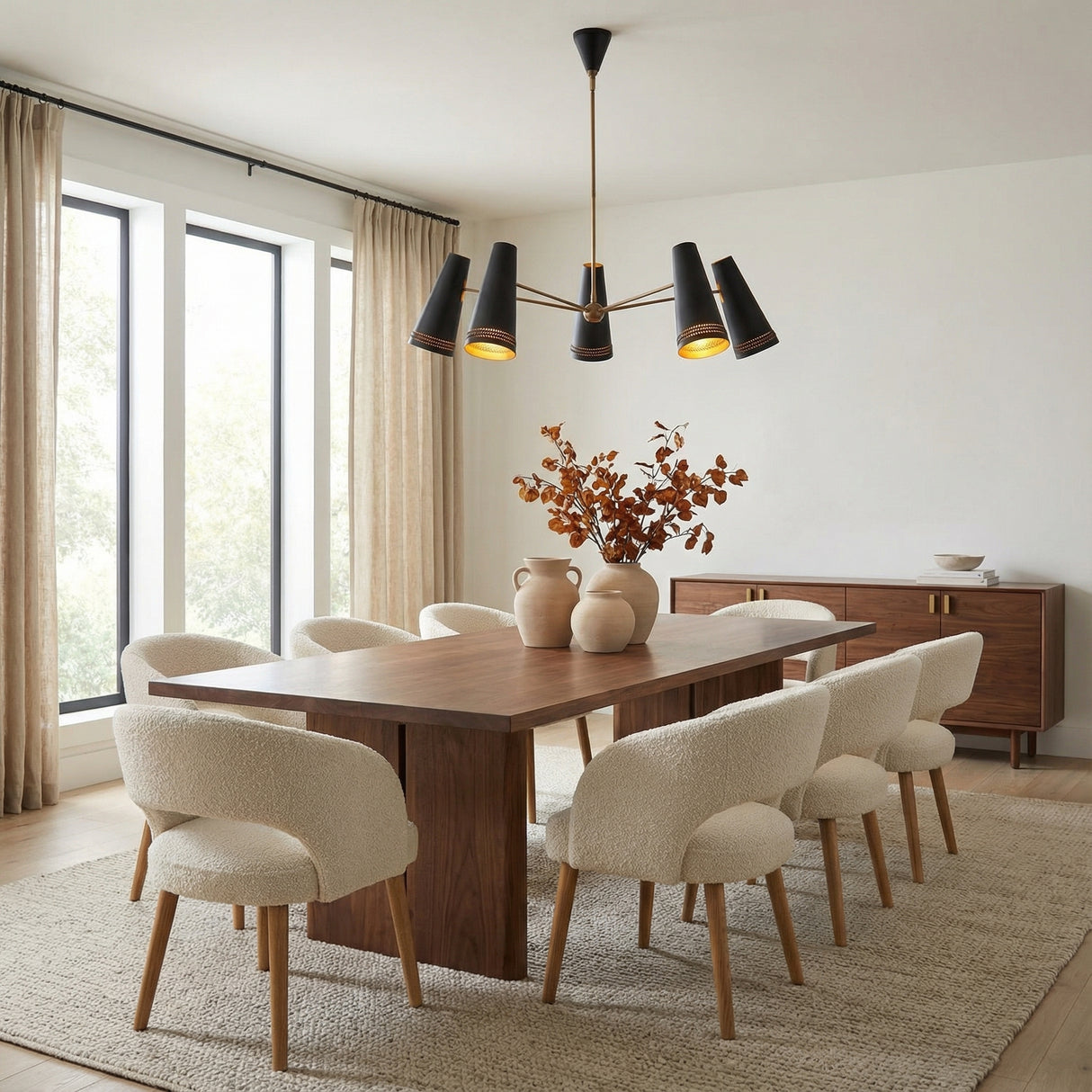 Darien 5 Light Chandelier 45", Matte Black with Hazelnut Leather geometric Chandelier in a Mid-Century Dining Room with a wooden dining table & bouclé chairs.