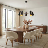 Darien 5 Light Chandelier 45", Matte Black with Hazelnut Leather geometric Chandelier in a Mid-Century Dining Room with a wooden dining table & bouclé chairs.